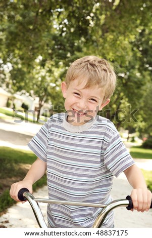Smiling boy on a bike