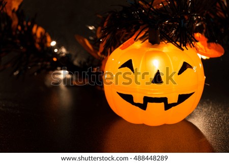 Halloween pumpkin party, happy pumpkin lighten and reflection on black background.