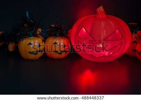 Halloween pumpkin party, Big terrible Pumpkin and happy pumpkin friends on wooden background.