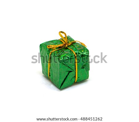 Big green gift on white background. Christmas gift box in foliage wrapping with gold thread bow. New year fir tree ornament. Winter holiday symbol isolated. Christmas present image for season decor