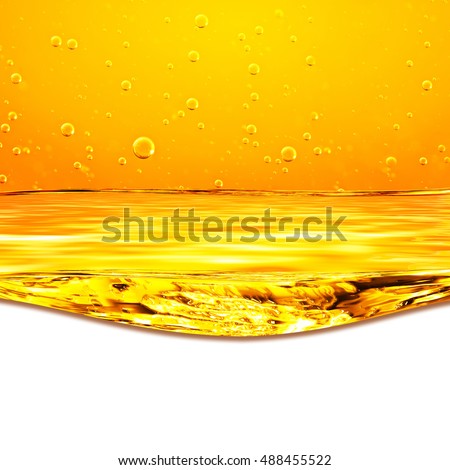 Oil. Honey. Beer. Juice. Orange yellow Flows Liquid with oxygen bubbles. Closeup. Orange yellow waves and white background for text below.