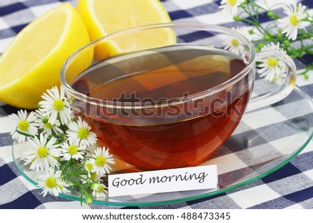 Good morning card with cup of tea, chamomile flowers and fresh lemon

