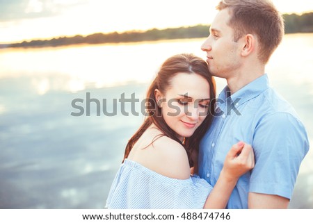 Happy couple hugging and laughing together at the beach . Young couple in love