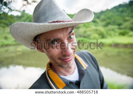smiling cowboy on the background of nature