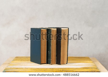 Stack of hardback books on wooden table. Back to school. Top view
