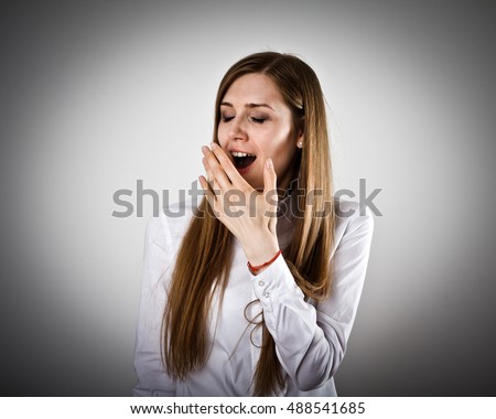 Woman in white is yawning. Boredom and yawn.