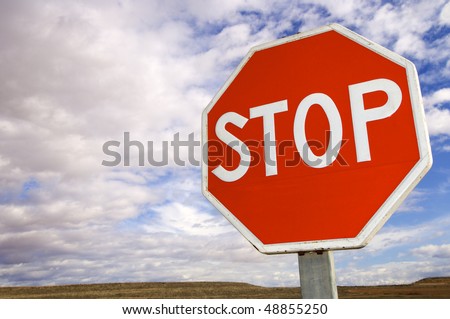 red stop signal with cloudy sky