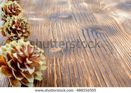 Several spruce cones on the wooden background. Abstract New Year's background.