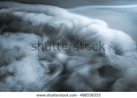 The flow of thick fume on a dark background