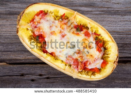 tomato and cheese stuffed spaghetti squash Royalty-Free Stock Photo #488585410