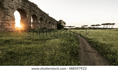 Ancient Roman empire aqueduct at sunset