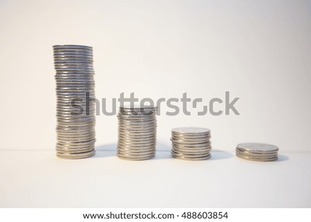 Silver coins stacked on an isolated white background
