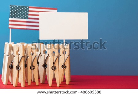 clothespins as illusion people, banners for  text,  Flag of the USA on patriotic background. toned abstract Photo card