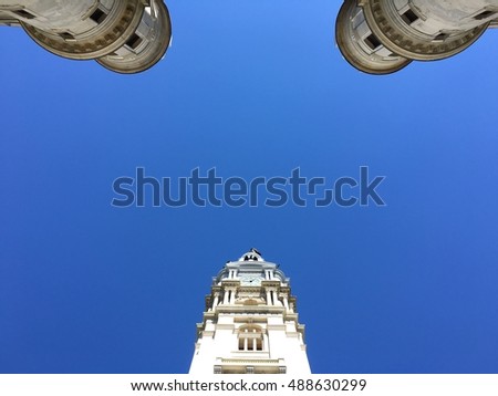 Philadelphia, PA City Hall looking up at the clocktower with bright blue sky.