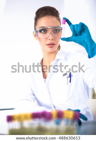 Woman researcher is surrounded by medical vials and flasks, isolated on white
