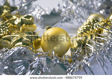 Christmas or New Year photo background with silver ribbon and gold fir tree toys. Festive winter holiday composition. Christmas greeting card. New Year banner template. Silver and gold decor picture
