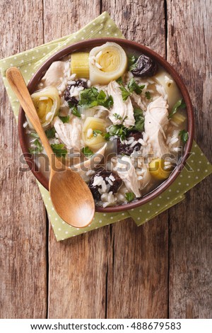 Scottish cock-a-leekie soup with leeks and prunes close up in a bowl on the table. Vertical view from above
 Royalty-Free Stock Photo #488679583