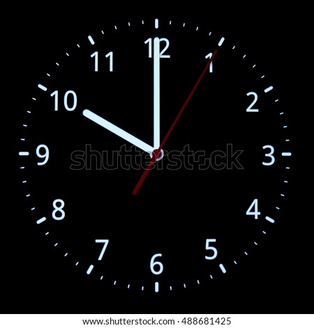analog clock on black background. conceptual of New Year and countdown.