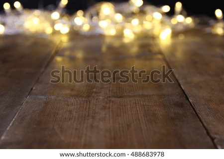 Abstract blurred christmas lights on wooden table