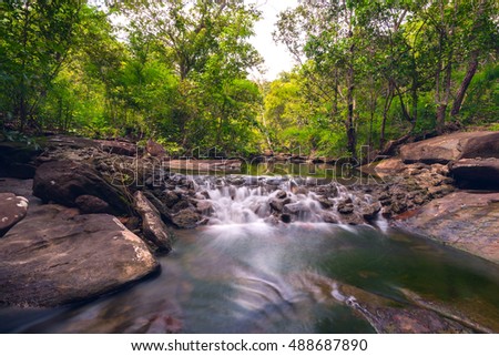 Huay Tha Long small waterfall in tropical forest,Ubon Ratchathani,Thailand,leaf moving low speed shutter blur