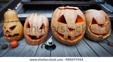 Halloween pumpkins on a wooden desk at night