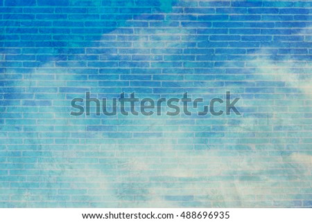 image of blue sky and white clouds on day time with cement brick wall texture screen for background usage.(vintage tone)