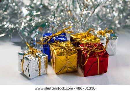 Christmas or New year flat composition. Silver ribbon background. Christmas presents. Red, blue, silver and gold gift wrapping. Closeup photo for greeting card or banner template. Winter holiday image