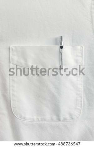 Close up pen in pocket on white shirt Royalty-Free Stock Photo #488736547