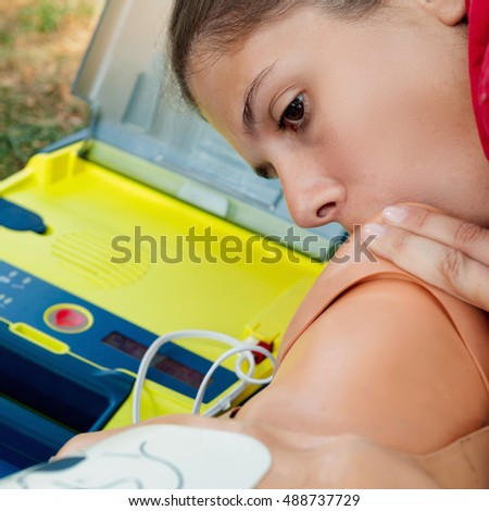 CPR training, mouth to mouth by young female