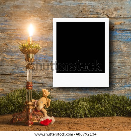 Christmas cards, vintage candle and Christmas decoration with empty picture frame for putting one photo