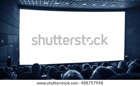 Cinema. The audience in 3D glasses watching a movie. A white screen for your image.