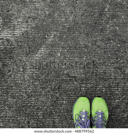 top of green exercise shoes stand of the corner of picture with concrete background