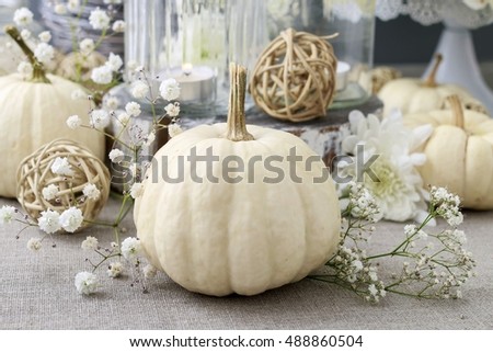 Floral decoration with white pumpkins called baby boo and chrysanthemum flowers.