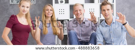 Panoramic view of a young people showing the word "if" using sign language