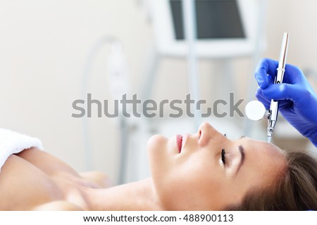 Picture of woman having facial treatment in beauty salon Royalty-Free Stock Photo #488900113
