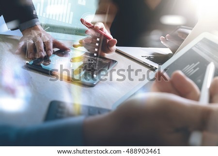 Business team present. Photo professional investor working with new startup project. Finance meeting.Digital tablet laptop computer design smart phone using, keyboard docking screen foreground