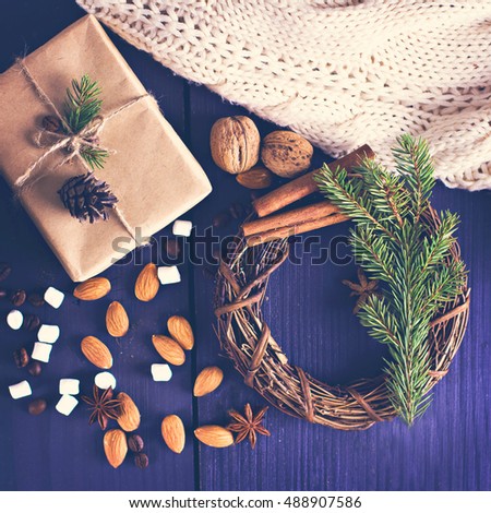 fir branch, nuts, cones, cozy knitted blanket. Winter, New Year, Christmas still life.