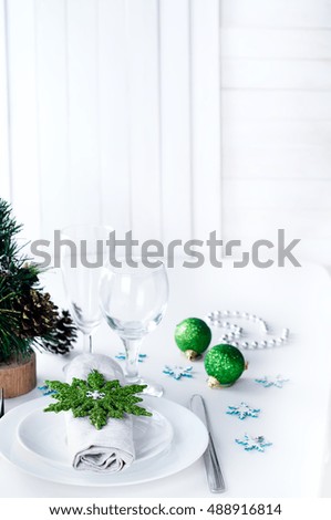 Christmas table setting in green with Christmas tree and toys