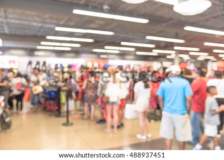 Blur image cashier with long line of people waiting at checkout counter in fitness store at outlet shopping mall in Houston, Texas, US. Cashier register and checkout payment concept background. Royalty-Free Stock Photo #488937451