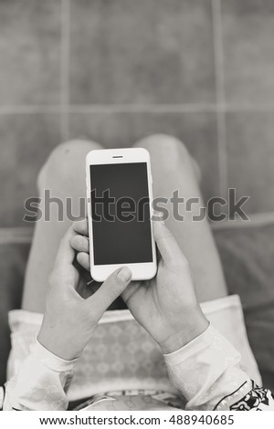 Black and white image closeup of smartphone in the hand on copy space background