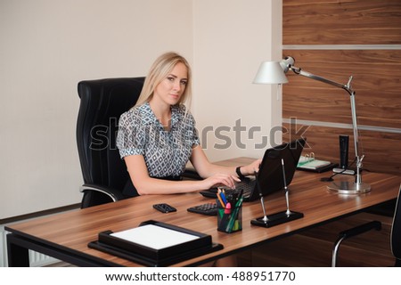 Beautiful business woman working with sales in her office