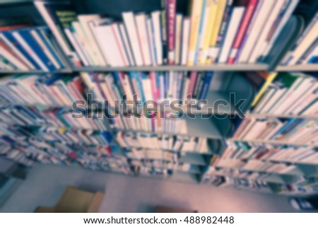 Blurred abstract background of book shelves row and interior of college library with library textbooks,library literature,library manuscript, library thesis and library magazines. - Vintage Tone.