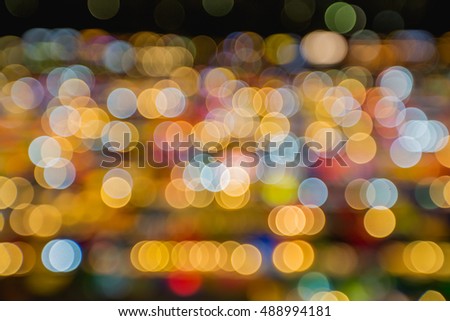 Abstract blur bokeh background of night market high view from building colorful tent retail shop and lighting at Rachada rain market Thailand