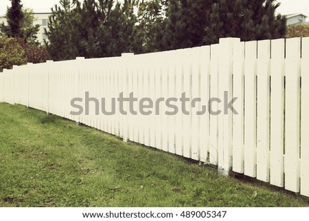 White picket fence. Image has a vintage effect applied.