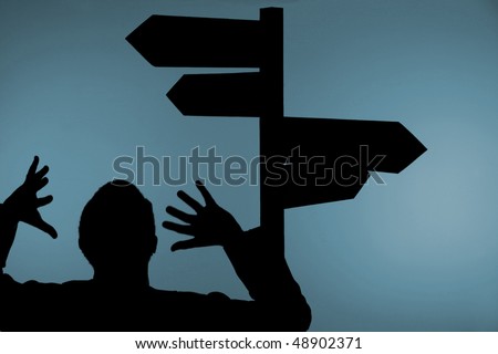 Silhouette of confused man with hands in air under multiple directional signpost, light blue background.