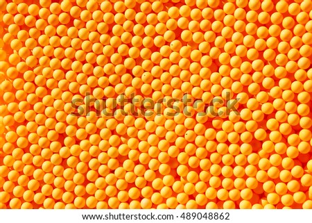 Abstract shot of hundreds of orange ping pong balls Royalty-Free Stock Photo #489048862