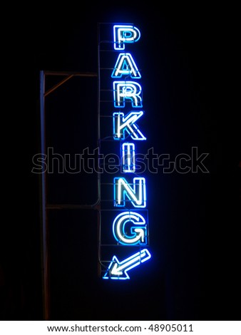 Parking sign neon light at night over dark sky
