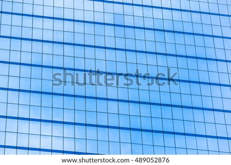 Blue glass windows of office building for background
