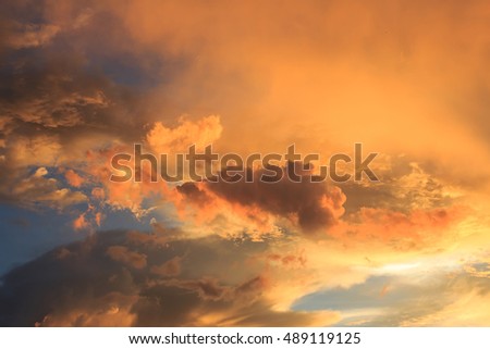 Fantastic red sunset and dark ominous clouds.Beautiful natural background and dramatic  blue cloudy sunset sky