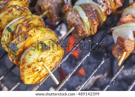 Close up picture of a zucchini and meat skewers, garden barbecue, selective focus.